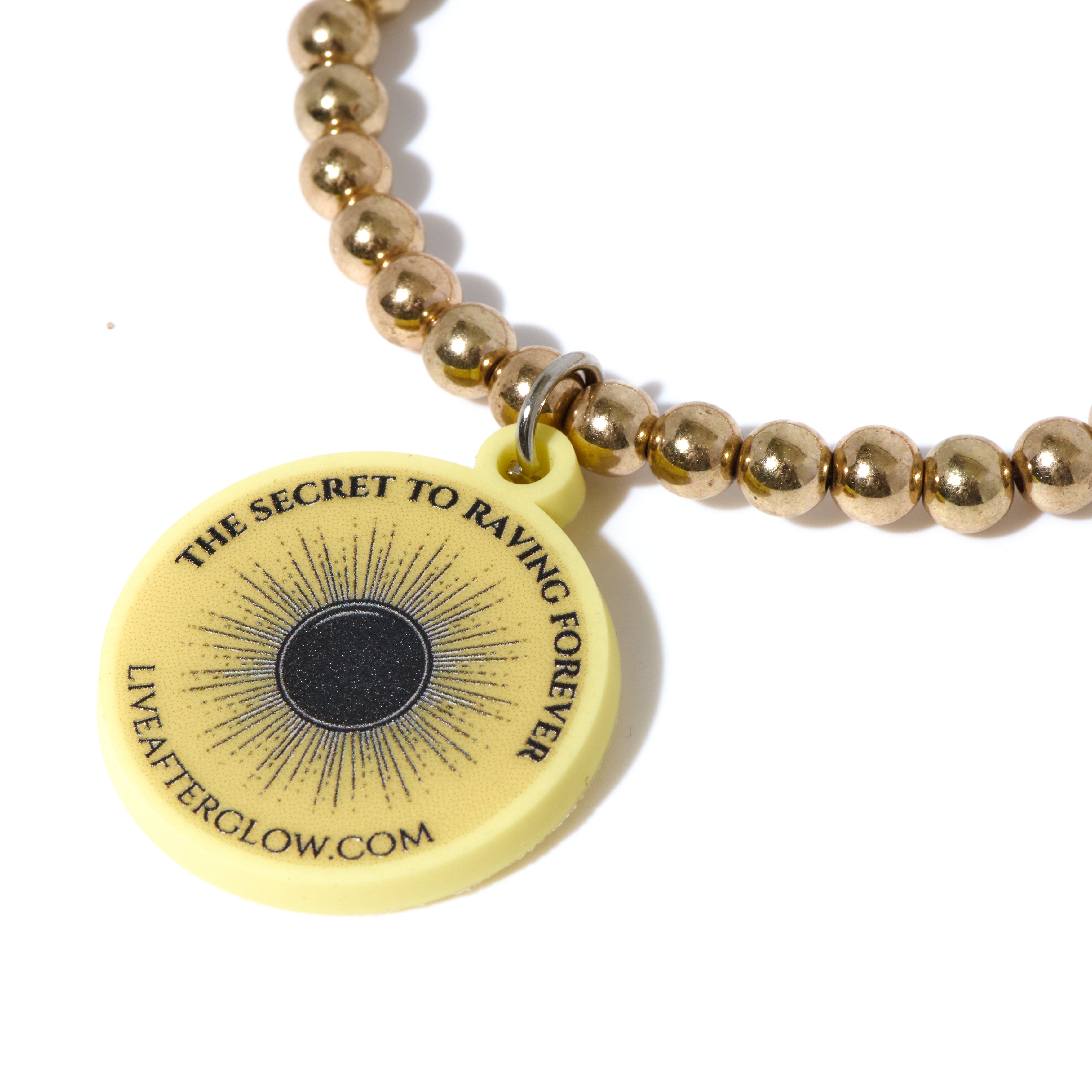 A gold AfterGlow bracelet, two included with each order
