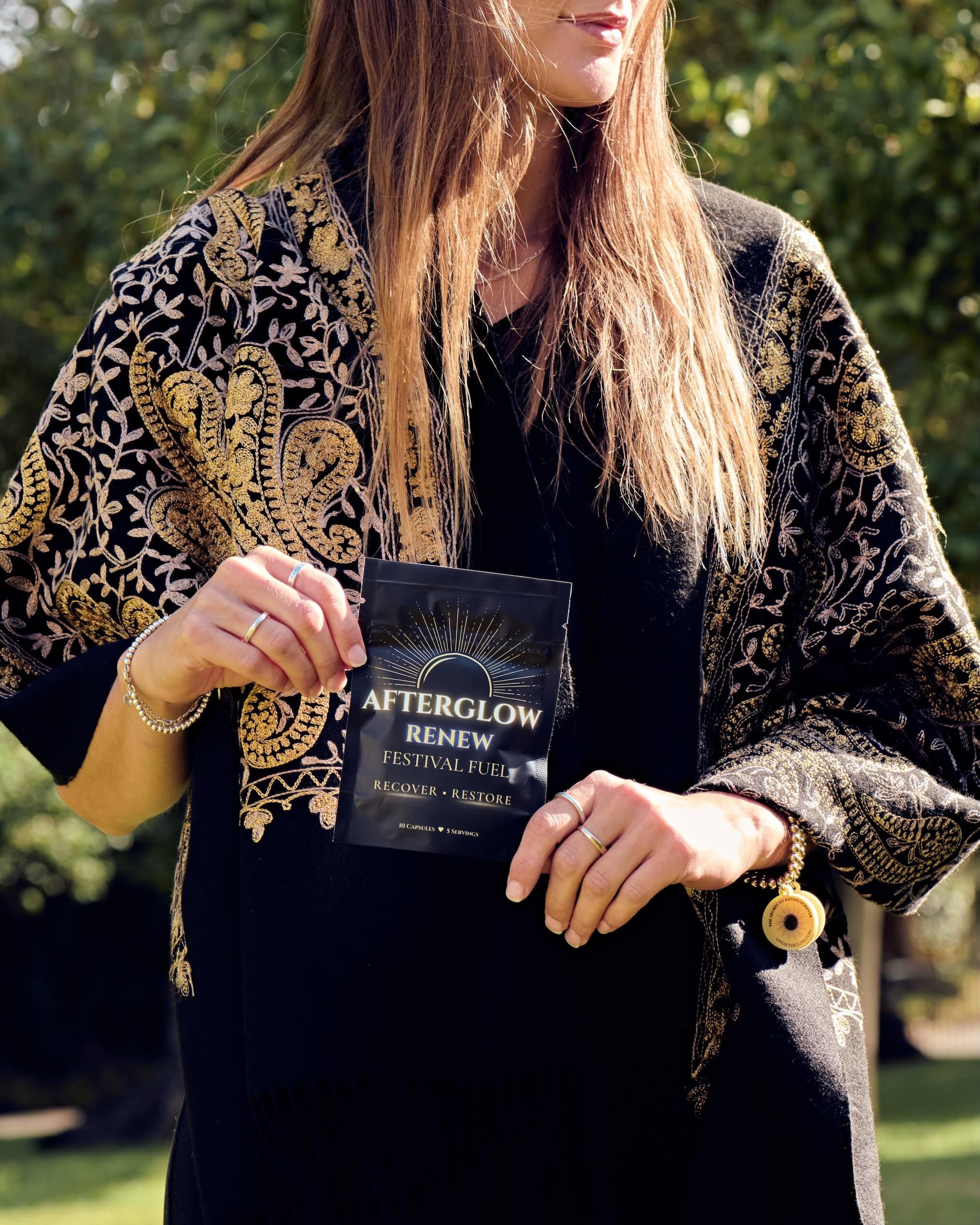 Woman holding AfterGlow Ignite up to the sky.